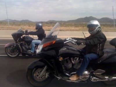 Zorana Barger and Sonny Barger are in the highway riding a bike side by side.